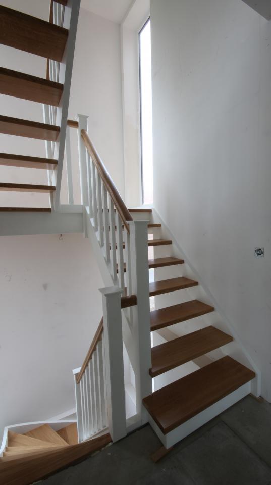 Escaliers cottage sur mesure. Colonnes carrées, fuseaux plats. Marches et main courante en chêne verni, le reste en peint en RAL 9010. Perwez.